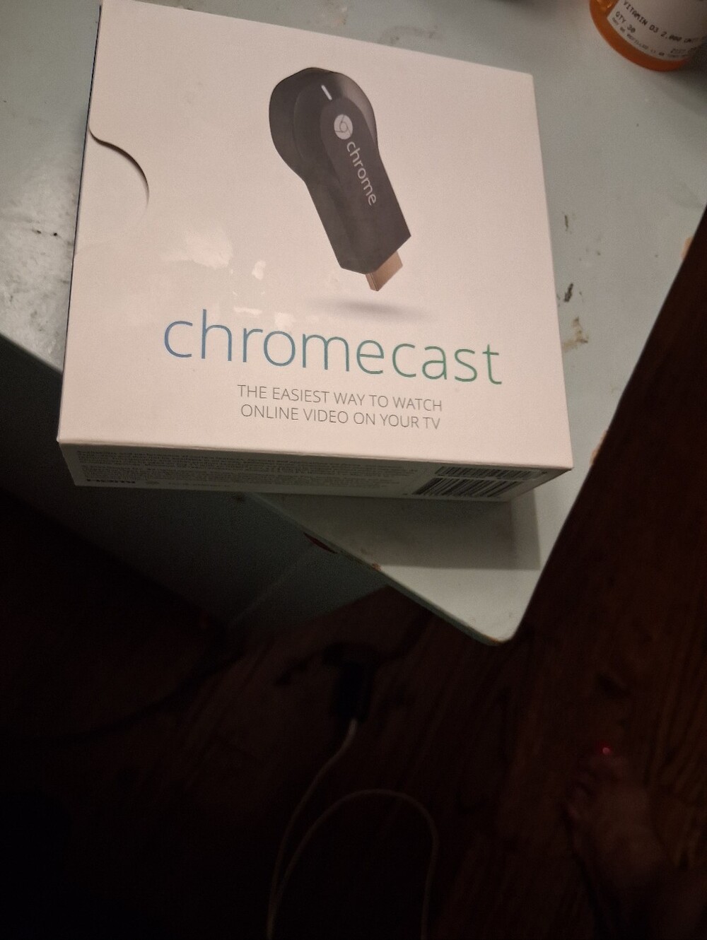 google Chromecast white box with black device image